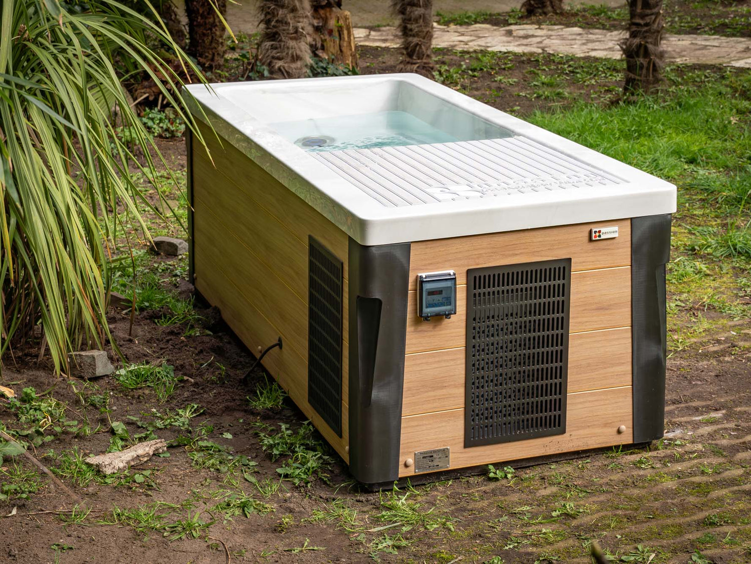 Modern rectangular Breeze Ice Bath with Current featuring wood-grain panels and cooling system in outdoor garden setting - Passion Ice Baths Collection
