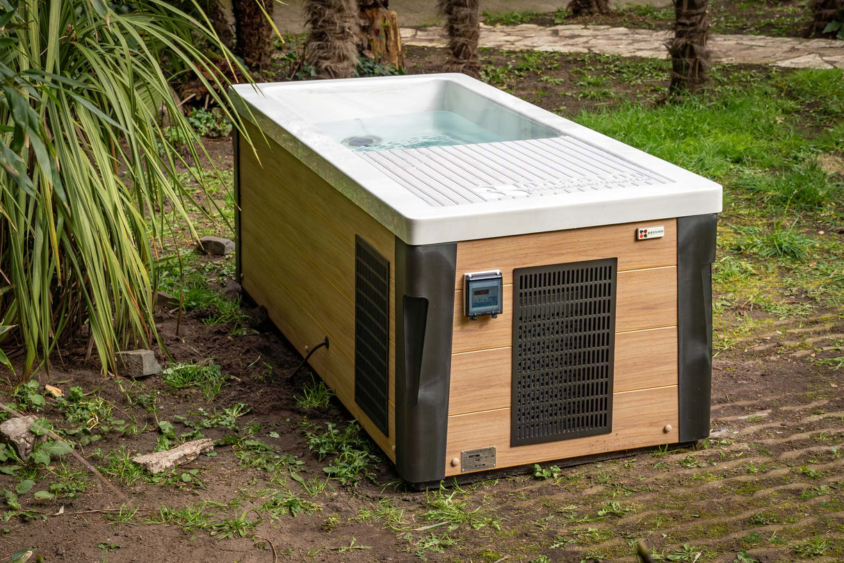 Modern rectangular Breeze Ice Bath with Current featuring wood-grain panels and cooling system in outdoor garden setting - Passion Ice Baths Collection