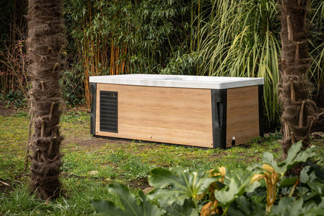 Breeze Ice Bath with Current in outdoor garden setting, bamboo-toned exterior, surrounded by tropical plants - Passion Ice Baths Collection