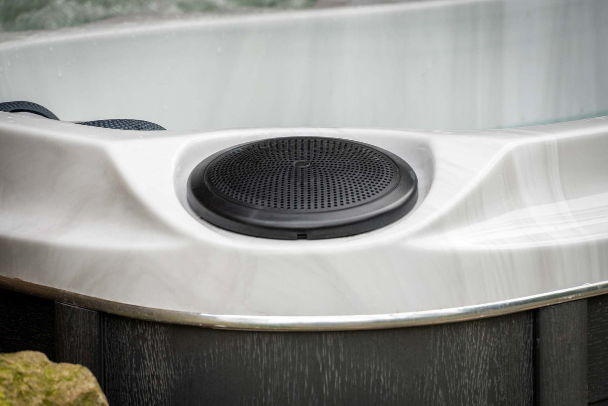 Circular black speaker detail on white Elevate ice bath surface, showcasing premium audio features - Passion Ice Baths Collection