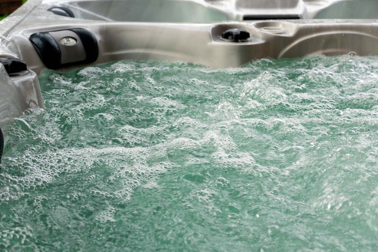 Elevate ice bath with bubbling turquoise water and therapeutic jets, showcasing hot and cold therapy features by Passion Ice Baths