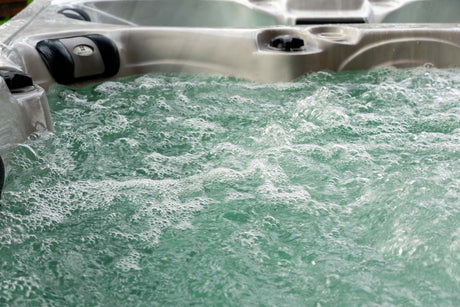 Elevate ice bath with bubbling turquoise water and therapeutic jets, showcasing hot and cold therapy features by Passion Ice Baths