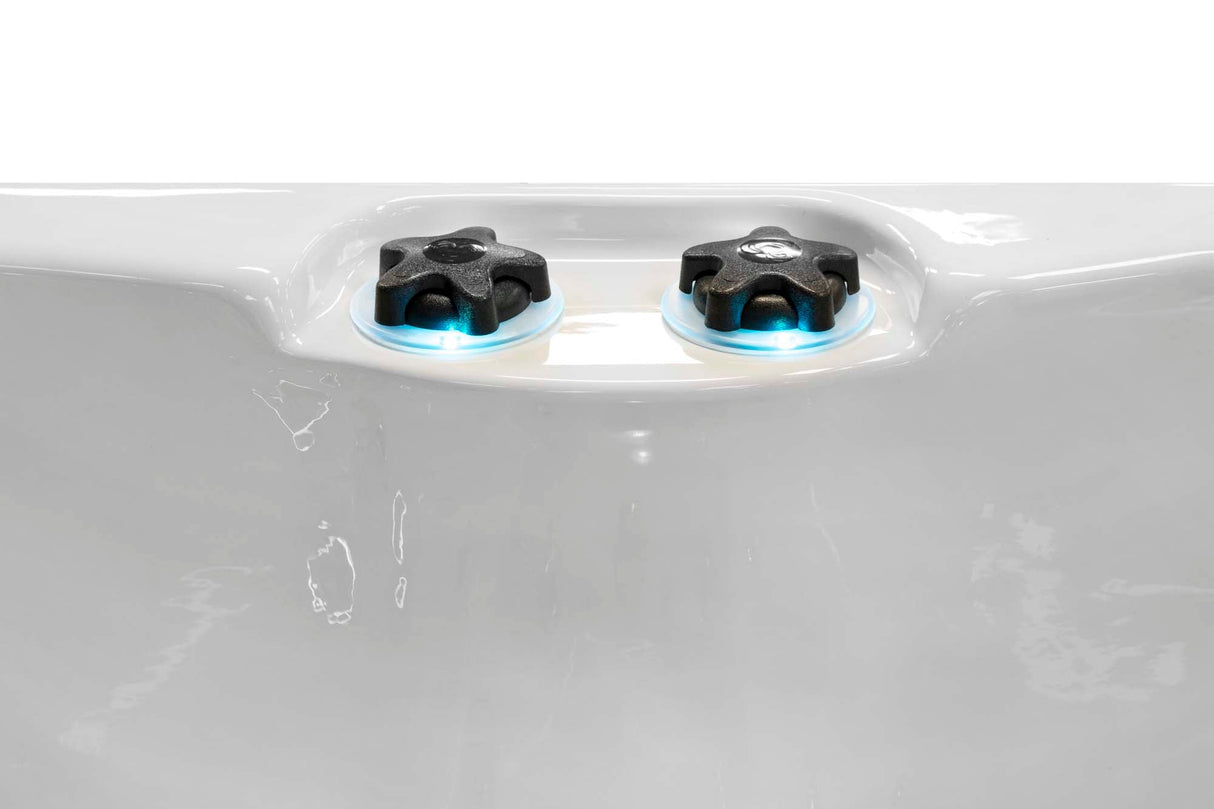 Close-up view of illuminated blue LED control knobs on Renew compact hot tub by Passion Spas Pure Collection Hot Tubs