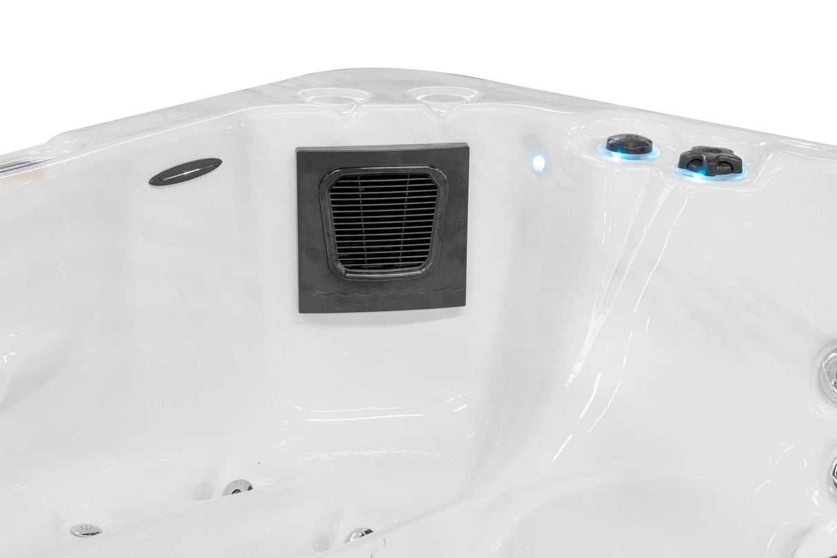 Renew 3-person hot tub featuring sleek white interior, black ventilation panel and blue control knobs - Passion Spas Pure Collection