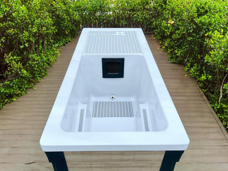 Modern Breeze ice bath with current system on wooden deck surrounded by greenery - Passion Ice Baths Collection
