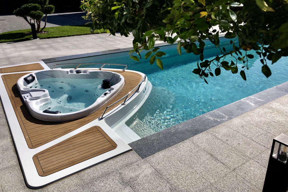 Heart hot tub with wooden deck surround installed poolside, featuring 2-person luxury seating - Passion Spas Signature Collection