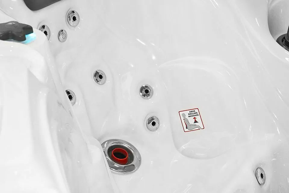 Modern white hot tub interior of Pleasure Spa showing hydrotherapy jets and ergonomic seating - Passion Spas Signature Collection