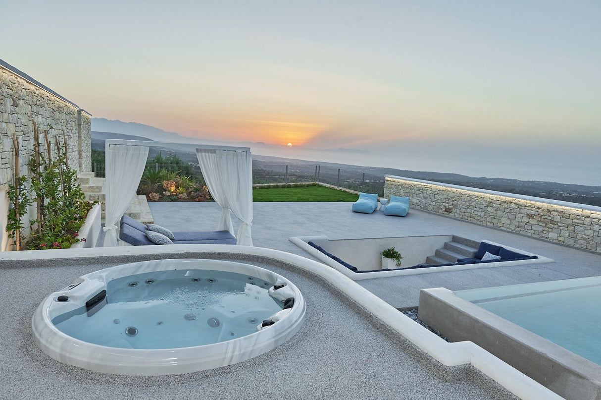 Recharge round spa at sunset with mountain views, luxury outdoor seating and canopy bed - Passion Spas Pure Collection Hot Tubs